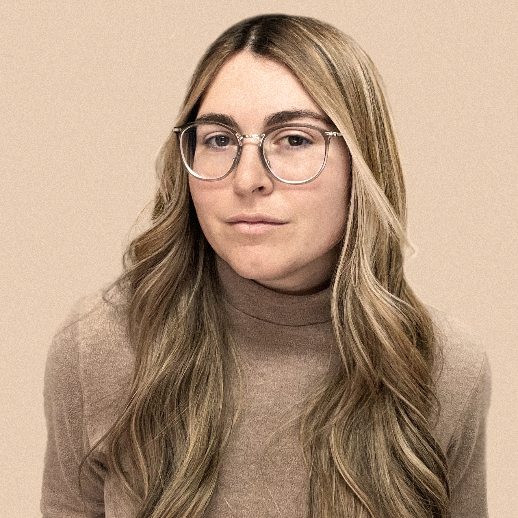 Blonde woman with glasses and tan shirt